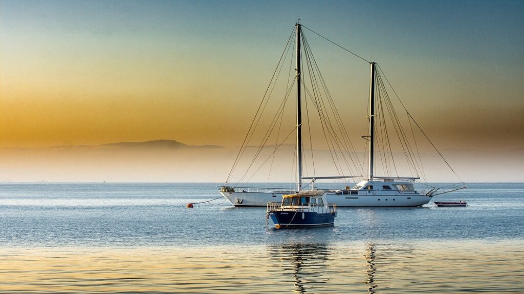 una barca a vela ferma in mare al tramonto