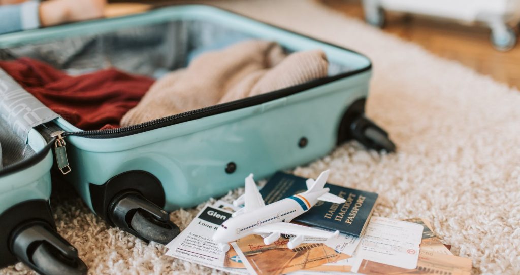 black and green luggage bag on brown carpet